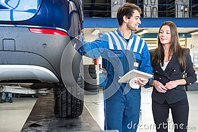 Friendly mechanic, showing a customer service his work Stock Photo